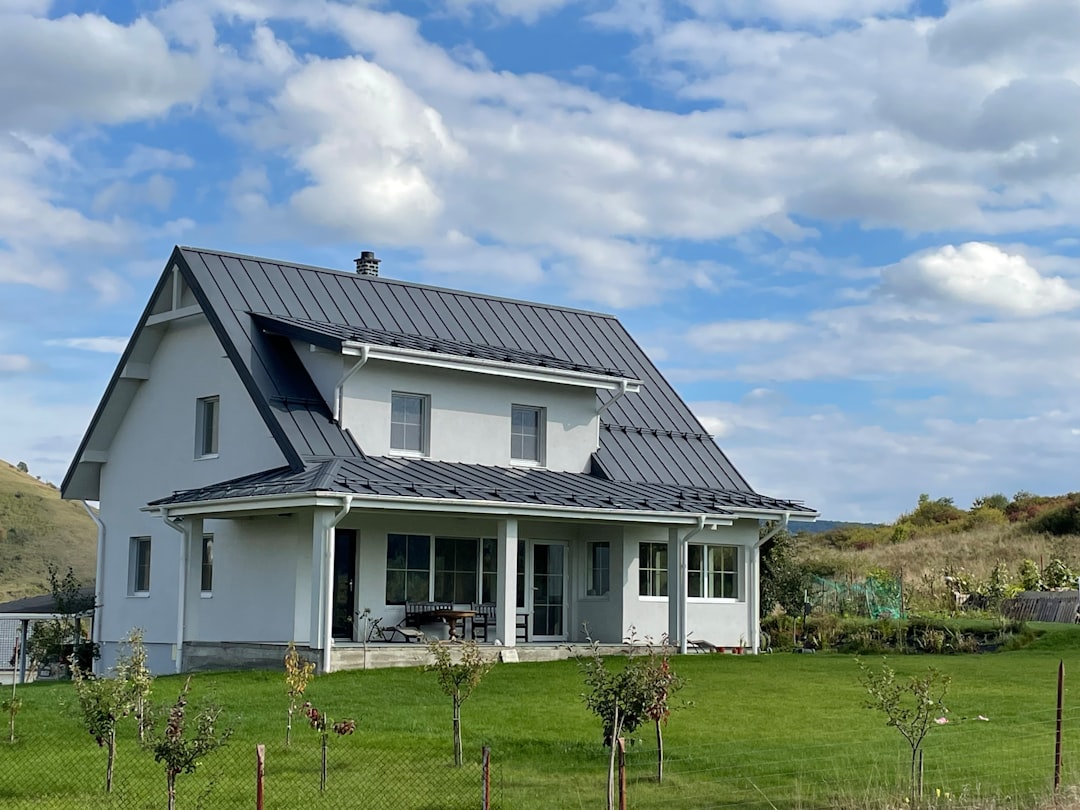 Modern residential home with solar panels installed on roof demonstrating solar energy system