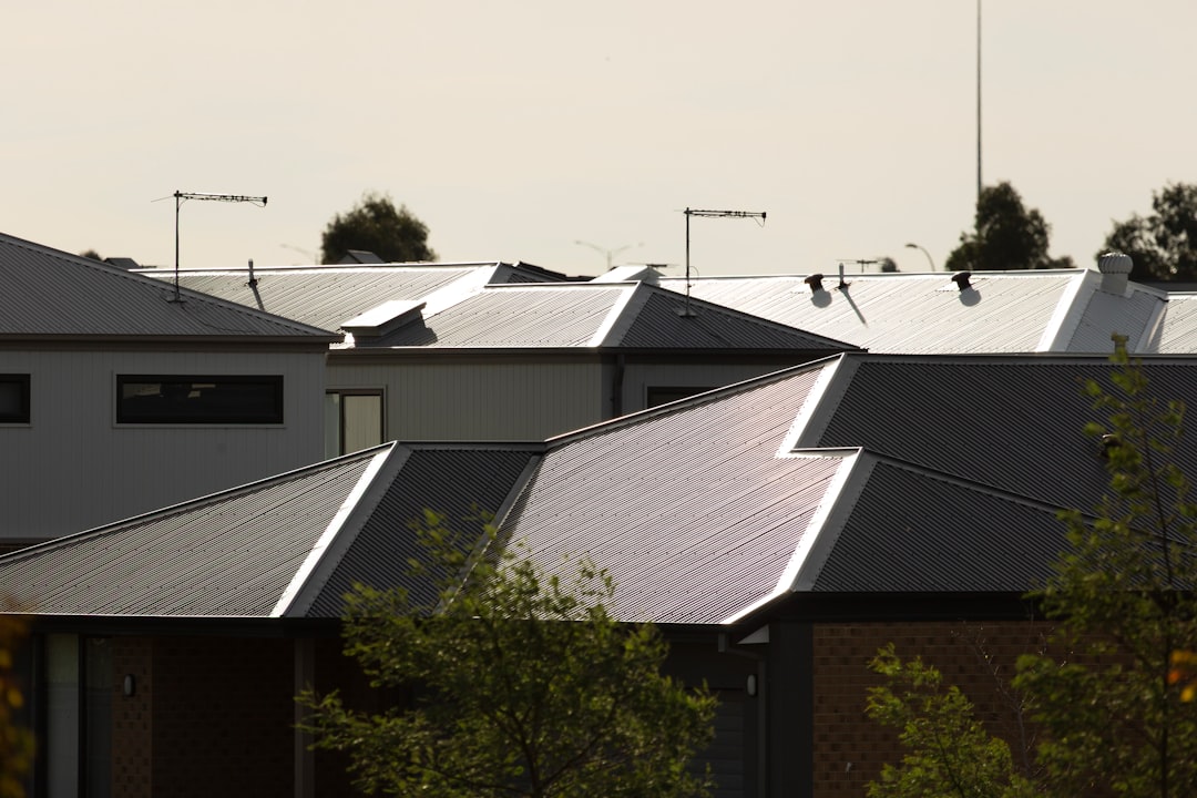 Modern residential houses with solar panels installed on roofs in Melbourne suburbs - perfect illustration for solar installation cost analysis